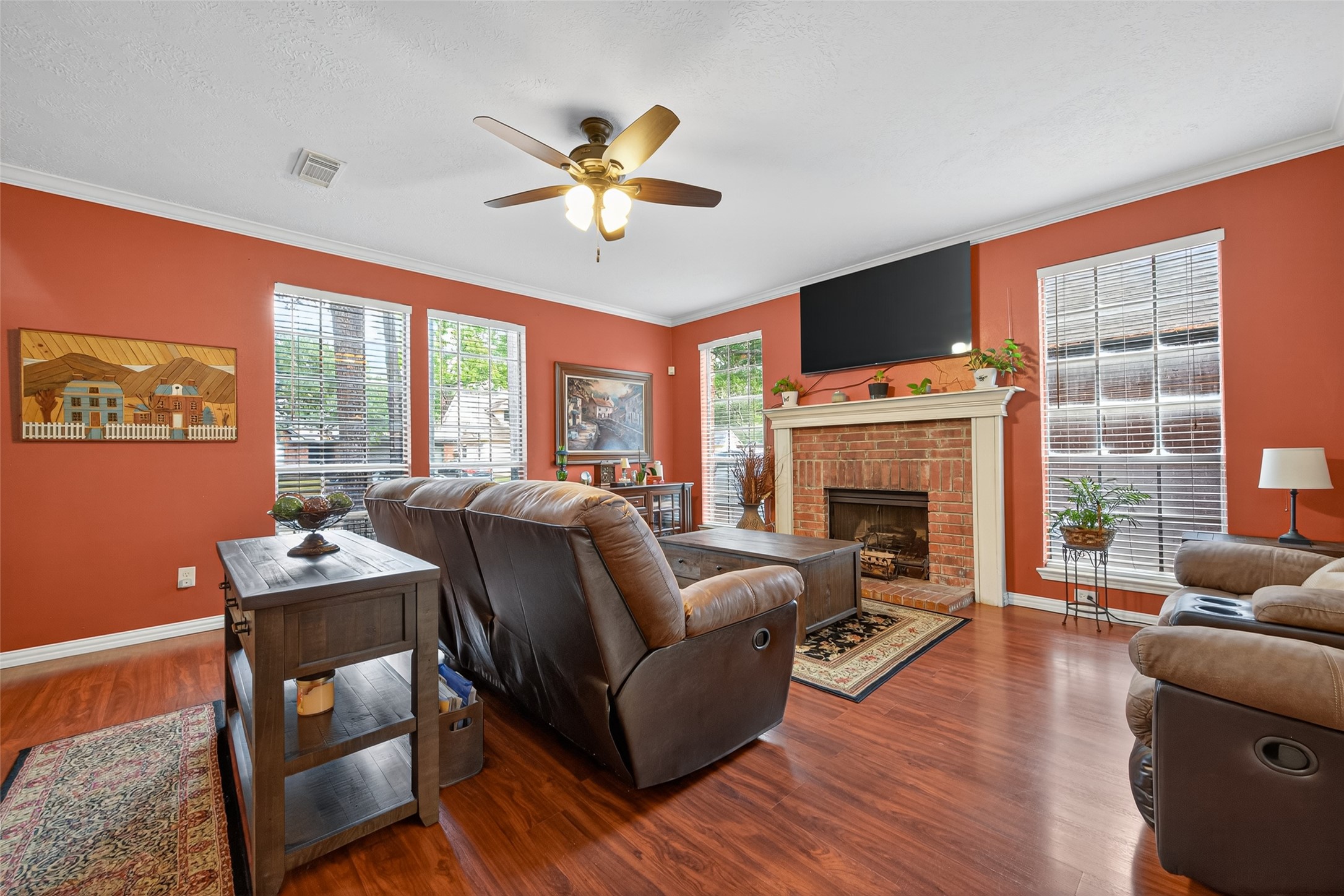 17215 Chaseloch Street Spring, TX 77379 - Photo 8 of 32 a living room with furniture a fireplace and a flat screen tv