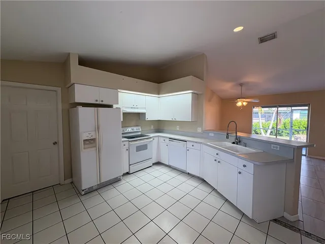 a kitchen with granite countertop cabinets and window