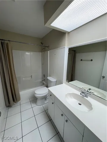a bathroom with a double vanity sink toilet and shower