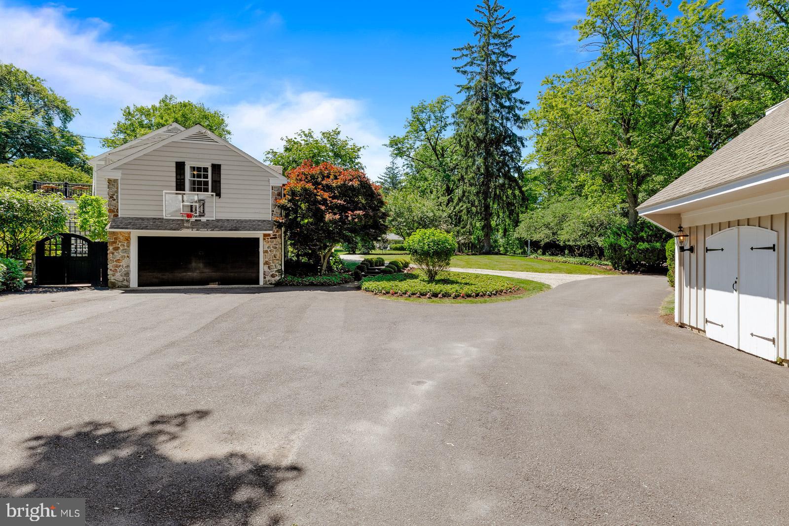 1700 Old Welsh Road Huntingdon Valley, PA 19006 - Photo 89 of 105 a front view of a house with a yard and garage
