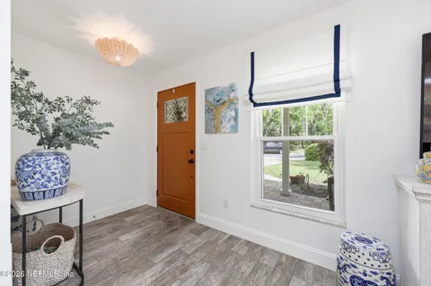 a view of room with window and wooden floor
