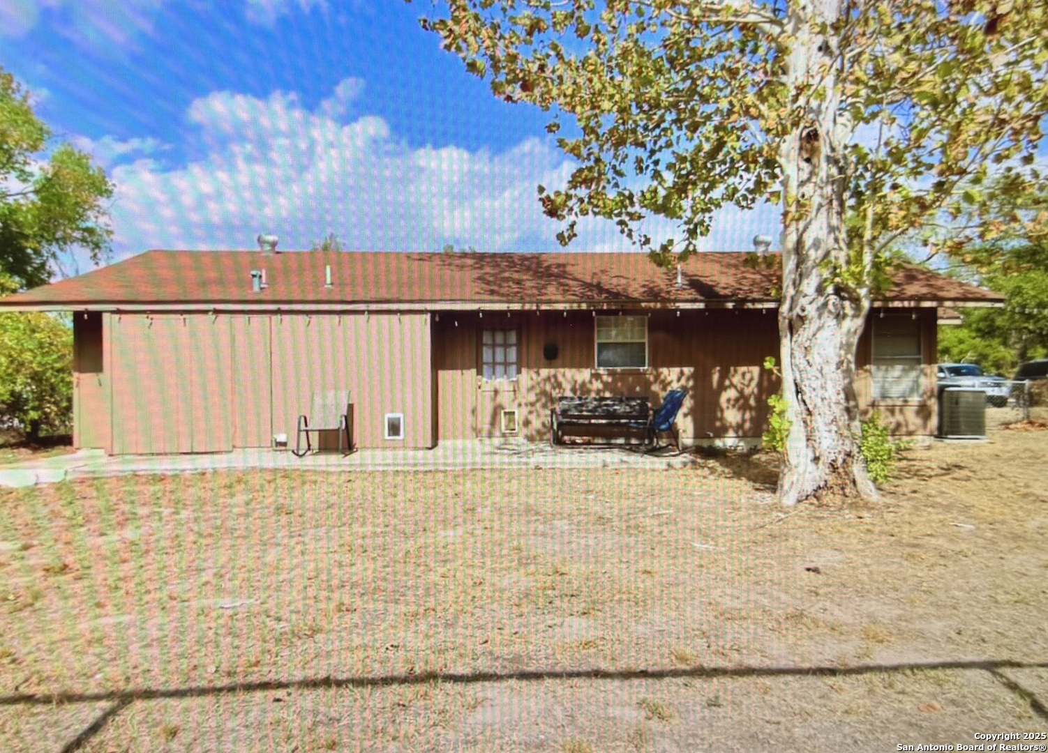 315 Mockingbird Lane Devine, TX 78016 - Photo 12 of 13 a front view of a house with a tree