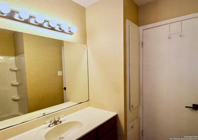 a bathroom with a sink and a mirror