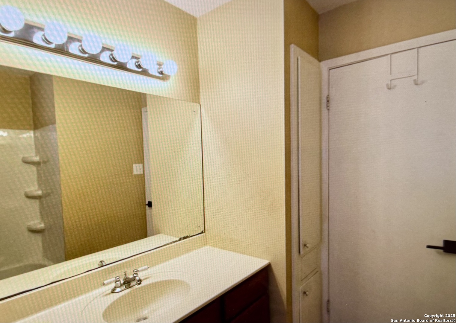 315 Mockingbird Lane Devine, TX 78016 - Photo 9 of 13 a bathroom with a sink and a mirror