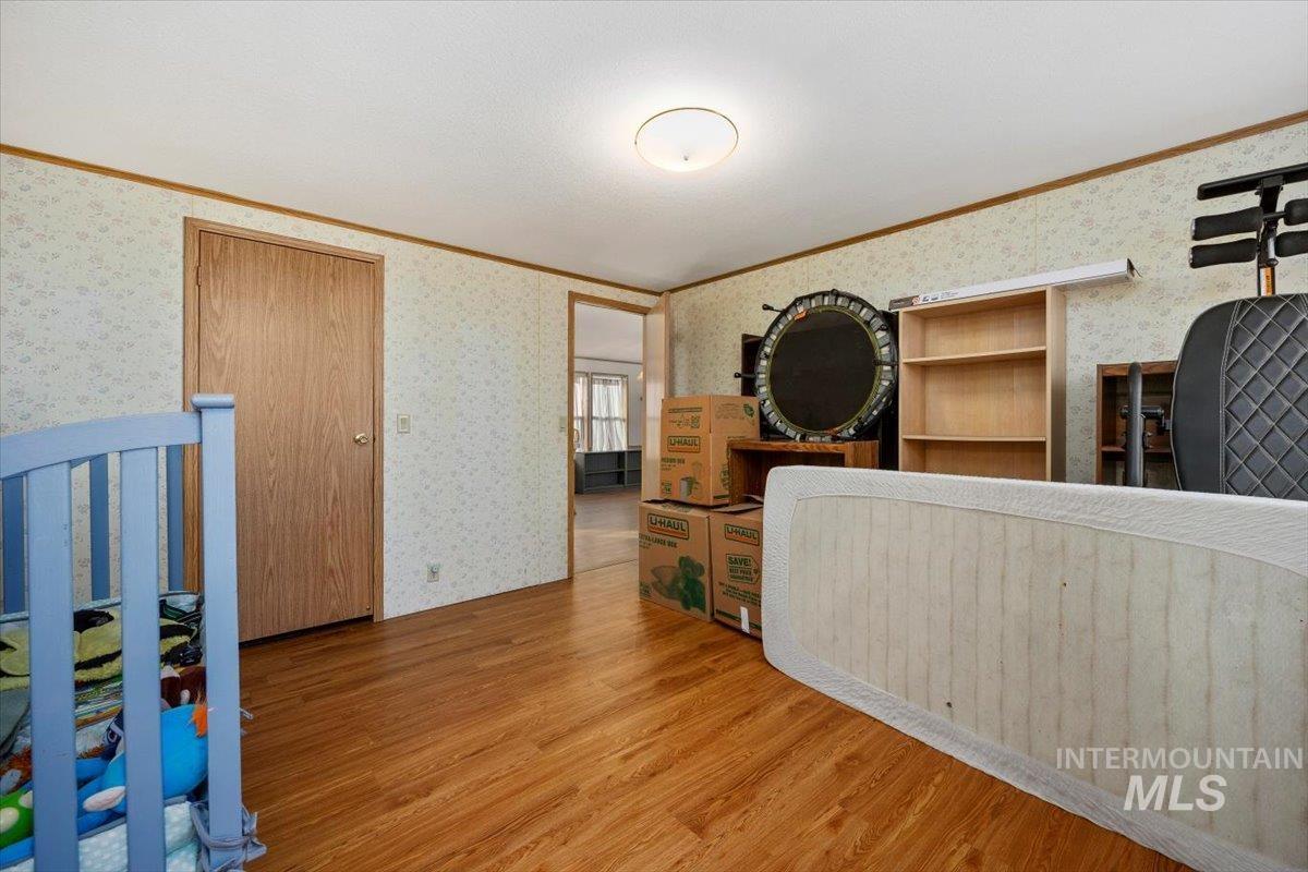 198 South Hills Road, Unit 142 Twin Falls, ID 83301 - Photo 20 of 27 Interior space with ornamental molding, wallpapered walls, and wood finished floors