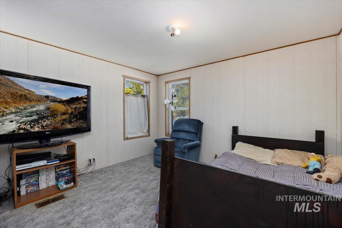 198 South Hills Road, Unit 142 Twin Falls, ID 83301 - Photo 22 of 27 Carpeted bedroom with ornamental molding