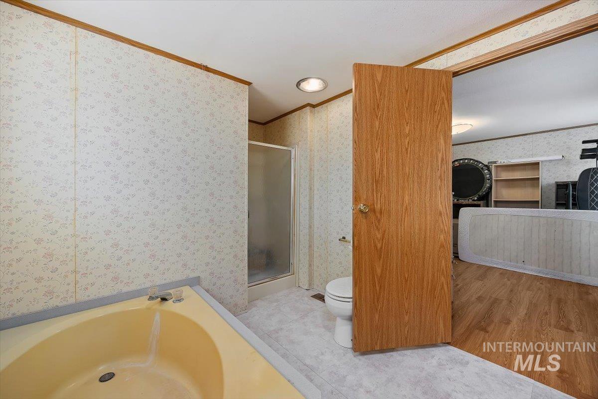 198 South Hills Road, Unit 142 Twin Falls, ID 83301 - Photo 23 of 27 Full bath featuring a stall shower, a garden tub, ornamental molding, and light wood-style flooring