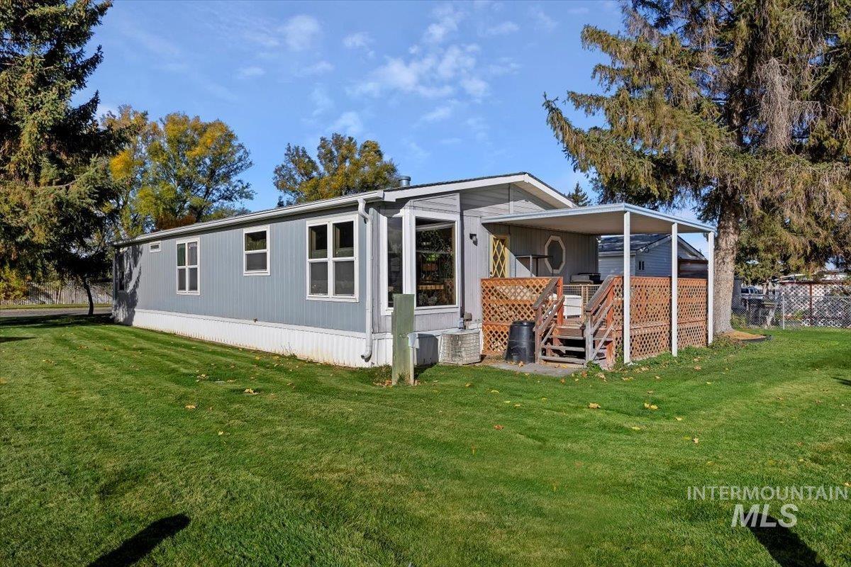 198 South Hills Road, Unit 142 Twin Falls, ID 83301 - Photo 27 of 27 Rear view of house with a lawn and a deck