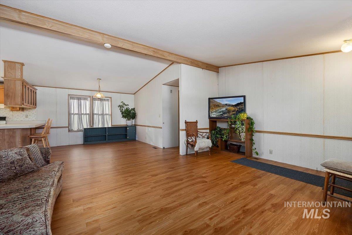 198 South Hills Road, Unit 142 Twin Falls, ID 83301 - Photo 6 of 27 Living area with light wood-style floors and wooden walls