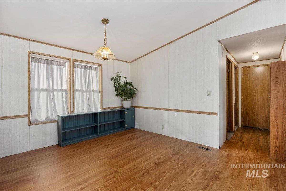 198 South Hills Road, Unit 142 Twin Falls, ID 83301 - Photo 7 of 27 Spare room with wood finished floors and ornamental molding