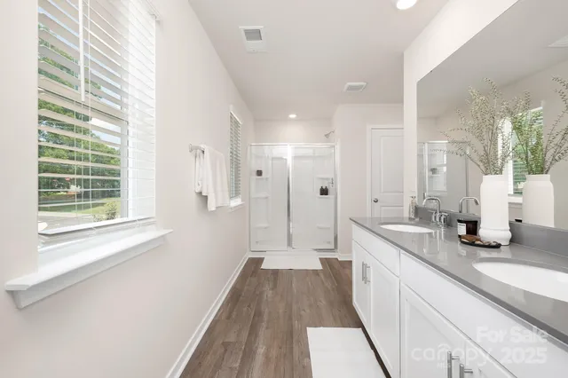 a bathroom with a double vanity sink and a mirror