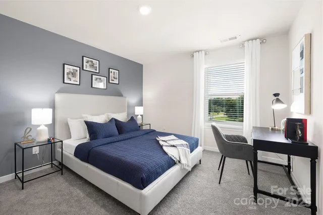 a bedroom with a bed and a table