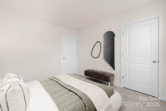 a bedroom with a bed and a mirror