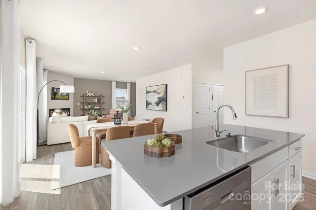a kitchen with white cabinets a sink and appliances