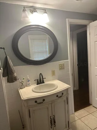 a bathroom with a toilet a sink and a window