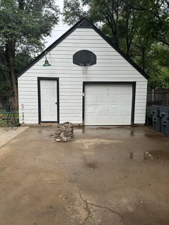 a backyard of a house with table and chairs