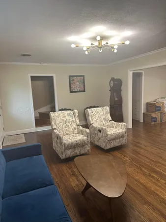 a bedroom with furniture and wooden floor