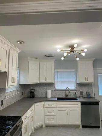 a kitchen with a sink cabinets and window
