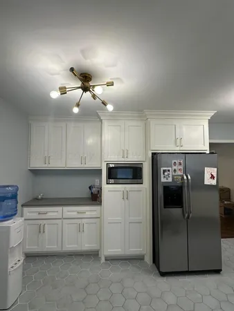 a kitchen with cabinets and white appliances