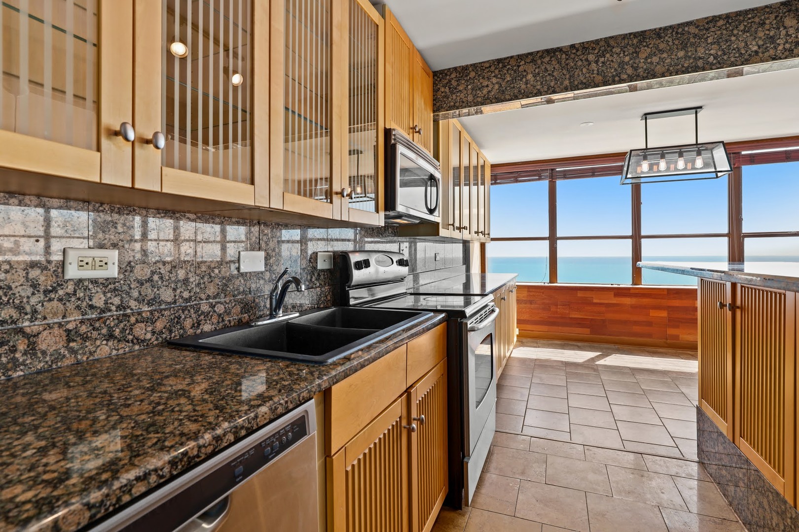 655 West Irving Park Road, Unit 4101 Chicago, IL 60613 - Photo 2 of 13 a kitchen with a sink and a stove