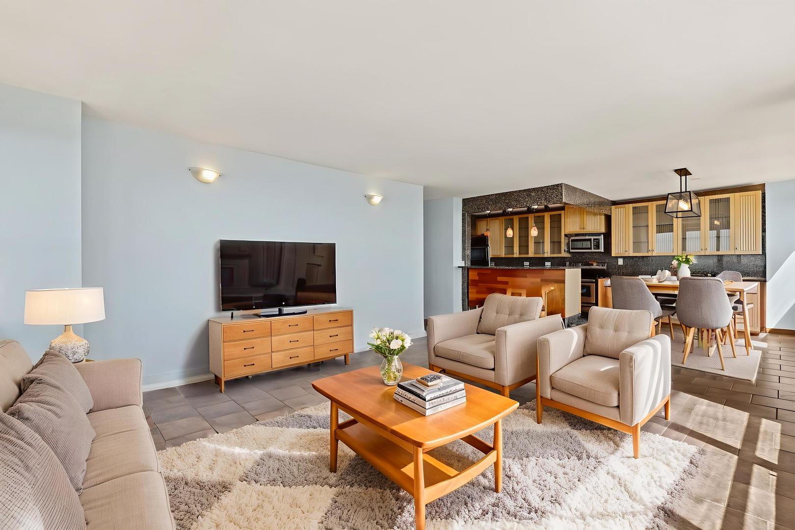 655 West Irving Park Road, Unit 4101 Chicago, IL 60613 - Photo 6 of 13 a living room with furniture and a flat screen tv