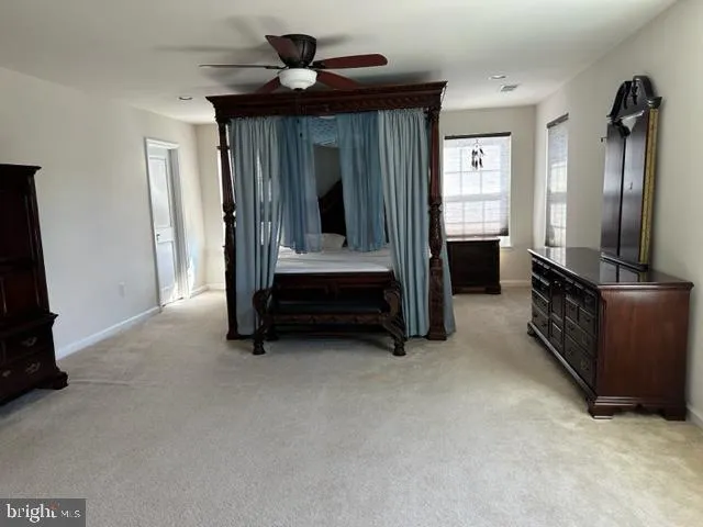 a view of room with furniture and a ceiling fan