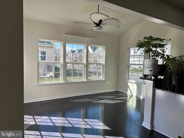 a living room with wooden floor and large windows
