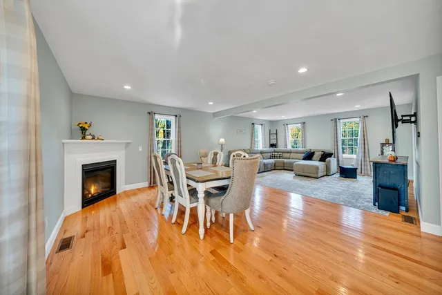 a living room with furniture a fireplace and a table