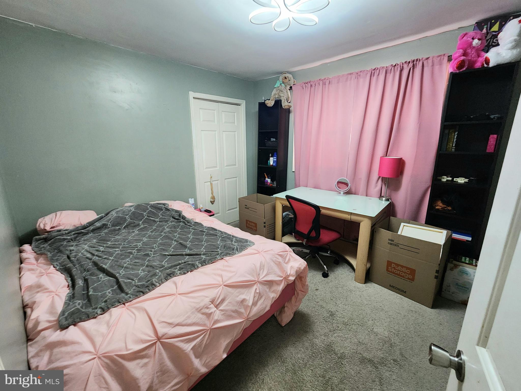 5209 Sumter Court Clinton, MD 20735 - Photo 15 of 24 a bedroom with a bed and a chandelier