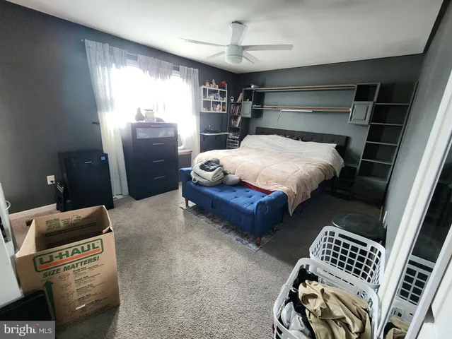 a bedroom with bed and window