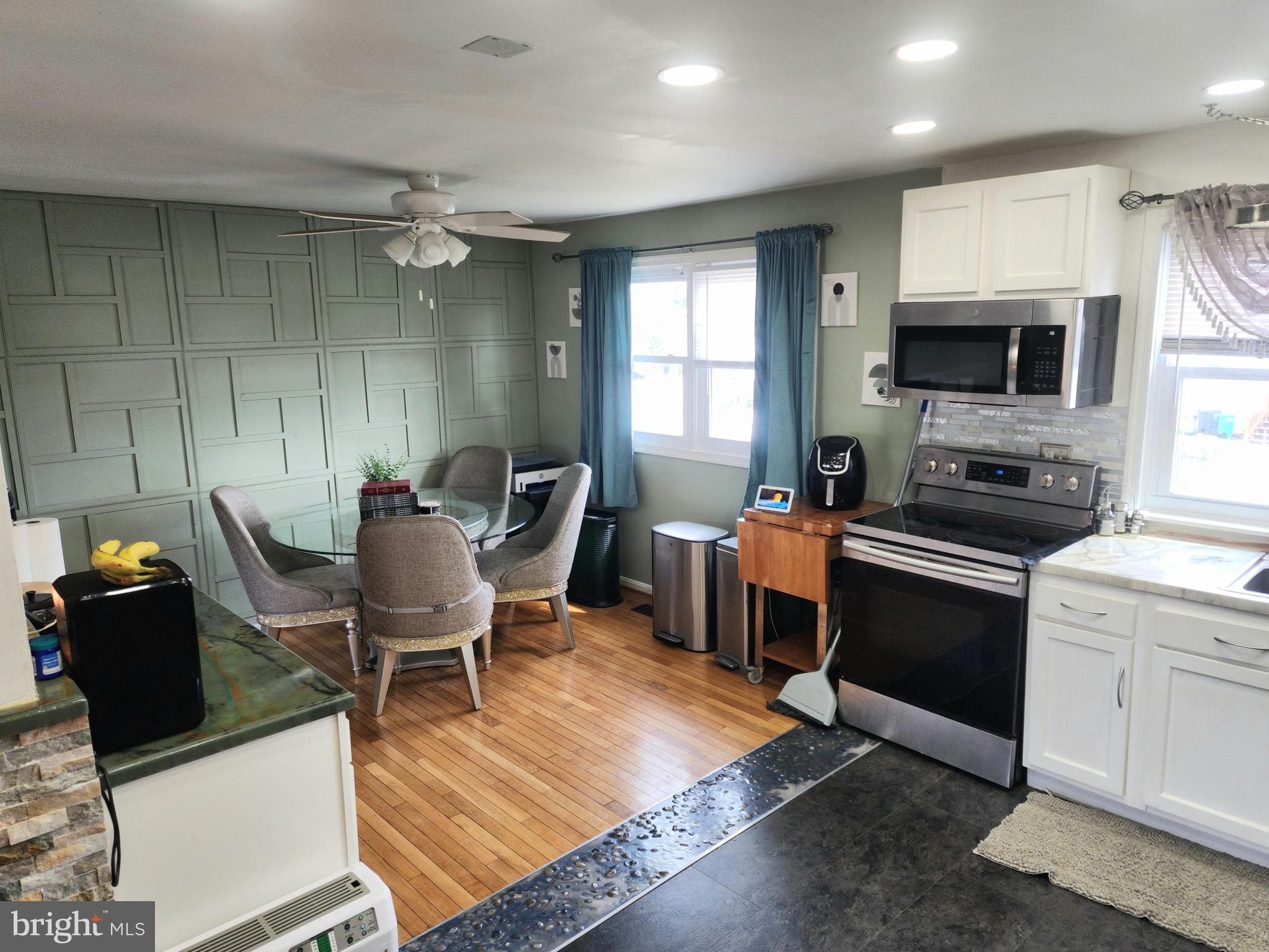 5209 Sumter Court Clinton, MD 20735 - Photo 7 of 24 a living room with furniture a flat screen tv and kitchen view