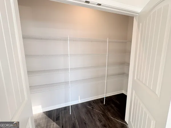 a close view of closet with wooden floor
