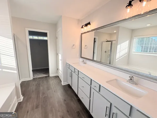 a spacious bathroom with double vanity and mirrors