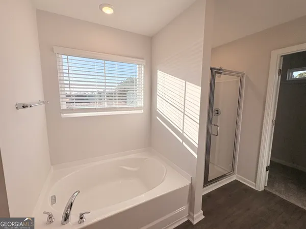 a bathroom with a bathtub and a window