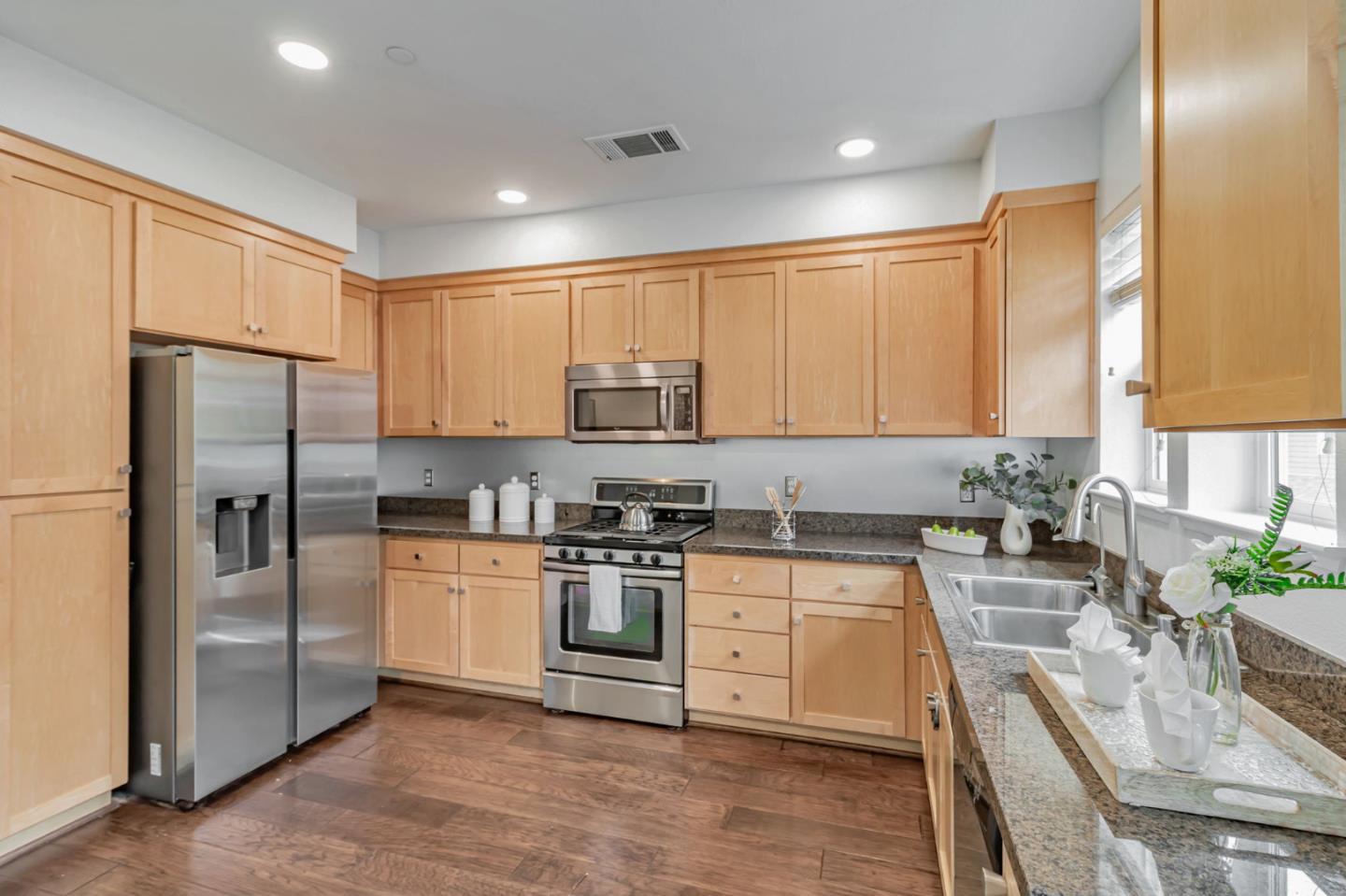 843 Avery Drive Mountain View, CA 94043 - Photo 13 of 43 a kitchen with stainless steel appliances granite countertop a stove a sink refrigerator and a microwave
