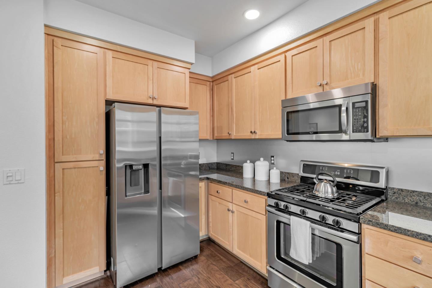 843 Avery Drive Mountain View, CA 94043 - Photo 15 of 43 a kitchen with stainless steel appliances granite countertop a stove a refrigerator and a microwave