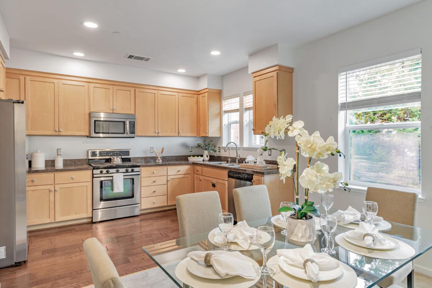843 Avery Drive Mountain View, CA 94043 - Photo 18 of 43 a kitchen with stainless steel appliances granite countertop a stove top oven a dining table and chairs