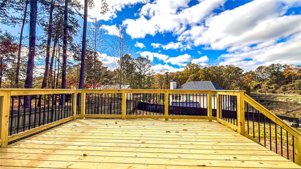 4094 Dollar Circle Suwanee, GA 30024 - Photo 11 of 56 a view of a balcony with wooden floor and fence