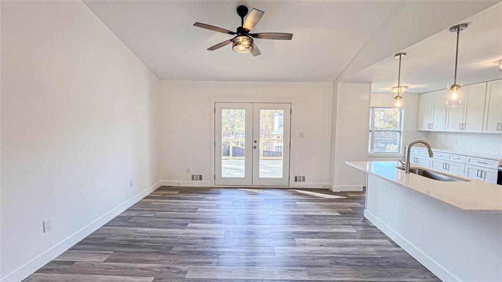 4094 Dollar Circle Suwanee, GA 30024 - Photo 24 of 56 a view of a kitchen with sink hardwood floor and a ceiling fan