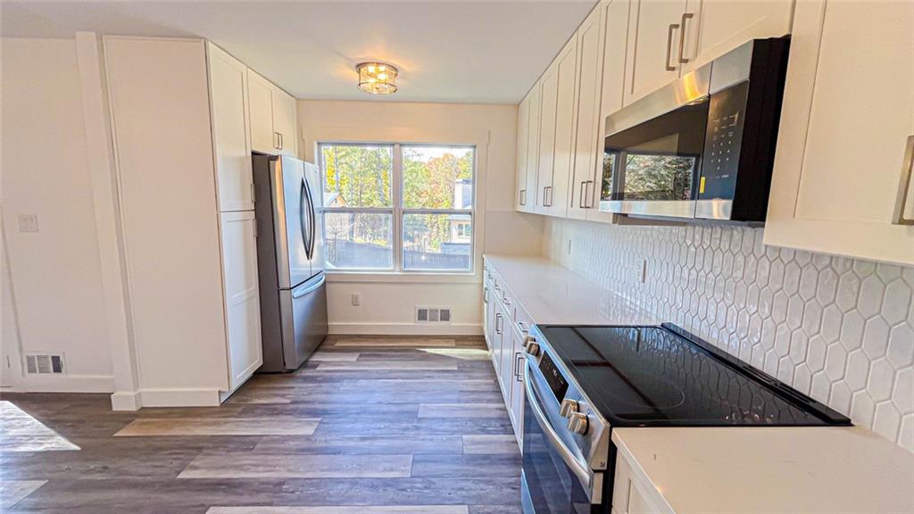 4094 Dollar Circle Suwanee, GA 30024 - Photo 29 of 56 a kitchen with a refrigerator and a window