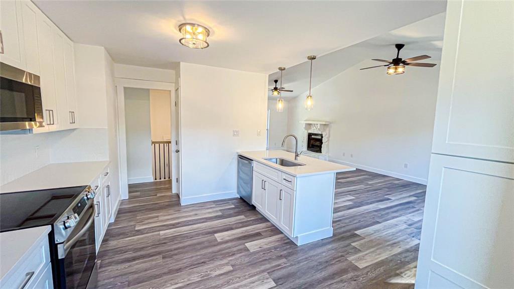 4094 Dollar Circle Suwanee, GA 30024 - Photo 30 of 56 a kitchen with a stove oven and wooden floor