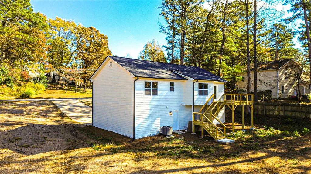 4094 Dollar Circle Suwanee, GA 30024 - Photo 3 of 56 a view of a wooden house with a yard