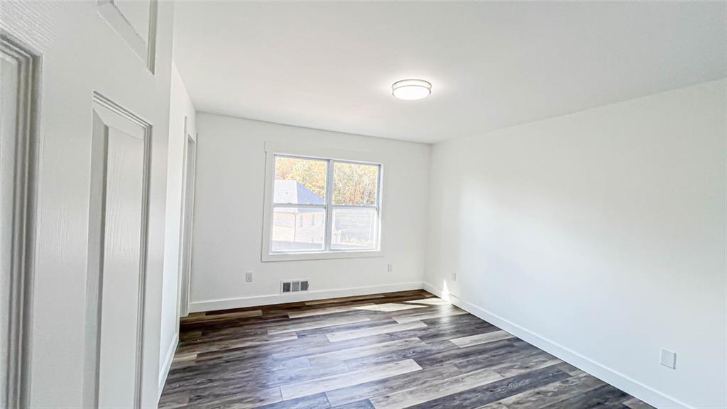 4094 Dollar Circle Suwanee, GA 30024 - Photo 31 of 56 an empty room with wooden floor and windows