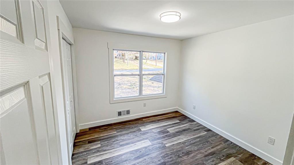 4094 Dollar Circle Suwanee, GA 30024 - Photo 37 of 56 an empty room with wooden floor and windows