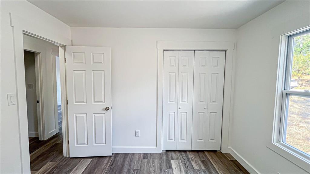 4094 Dollar Circle Suwanee, GA 30024 - Photo 38 of 56 an empty room with wooden floor windows and entryway