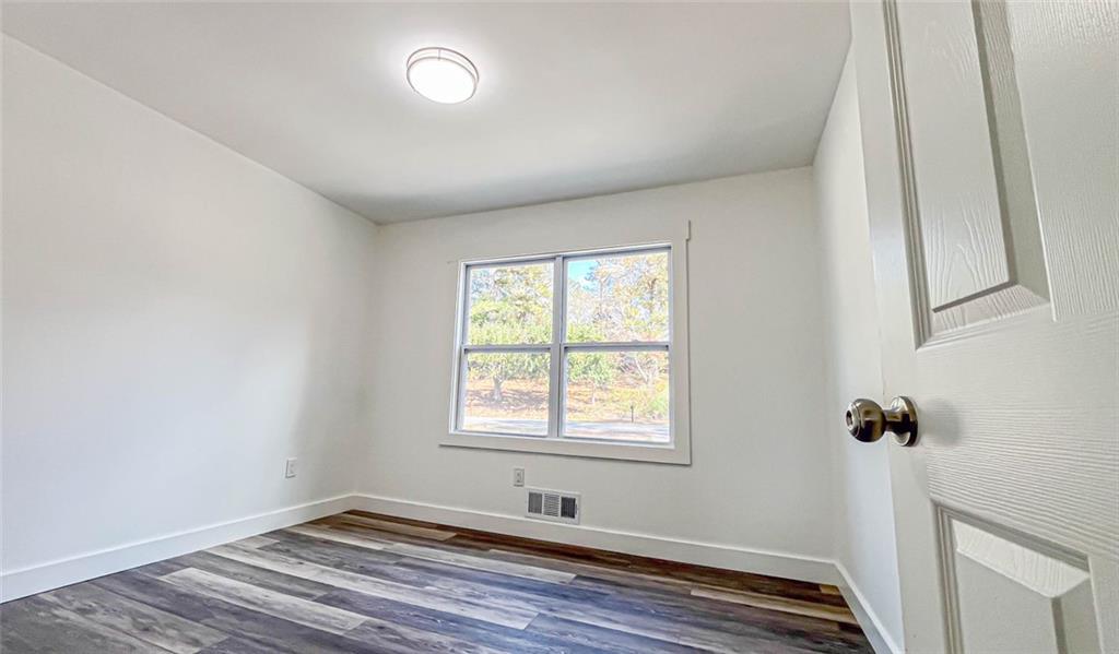 4094 Dollar Circle Suwanee, GA 30024 - Photo 40 of 56 a view of a room with wooden floor and windows