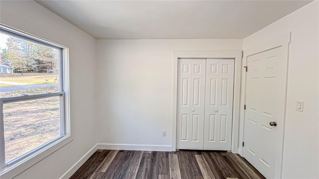 4094 Dollar Circle Suwanee, GA 30024 - Photo 41 of 56 a view of empty room with wooden floor and fan