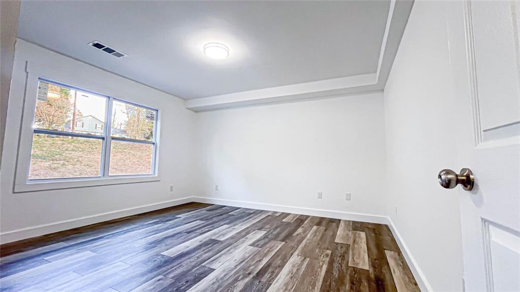 4094 Dollar Circle Suwanee, GA 30024 - Photo 45 of 56 a view of a room with wooden floor and natural light