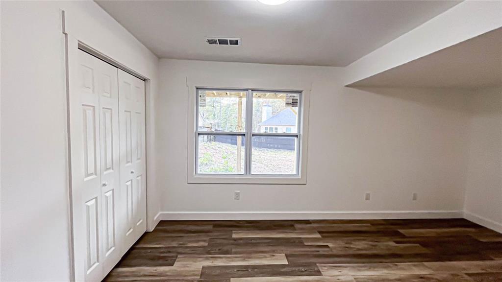 4094 Dollar Circle Suwanee, GA 30024 - Photo 47 of 56 an empty room with wooden floor and windows