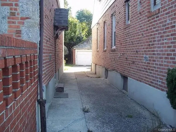 a view of a pathway along a brick building